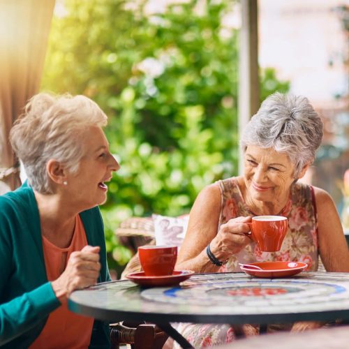 Coffee shop, funny and senior women talking, laughing and having friends reunion, retirement chat or social group. Restaurant, tea and elderly people in happy conversation for pension or cafe cafe