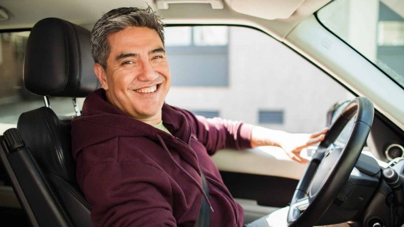 Middle,Aged,Latin,Man,Driving,A,Car,In,The,City